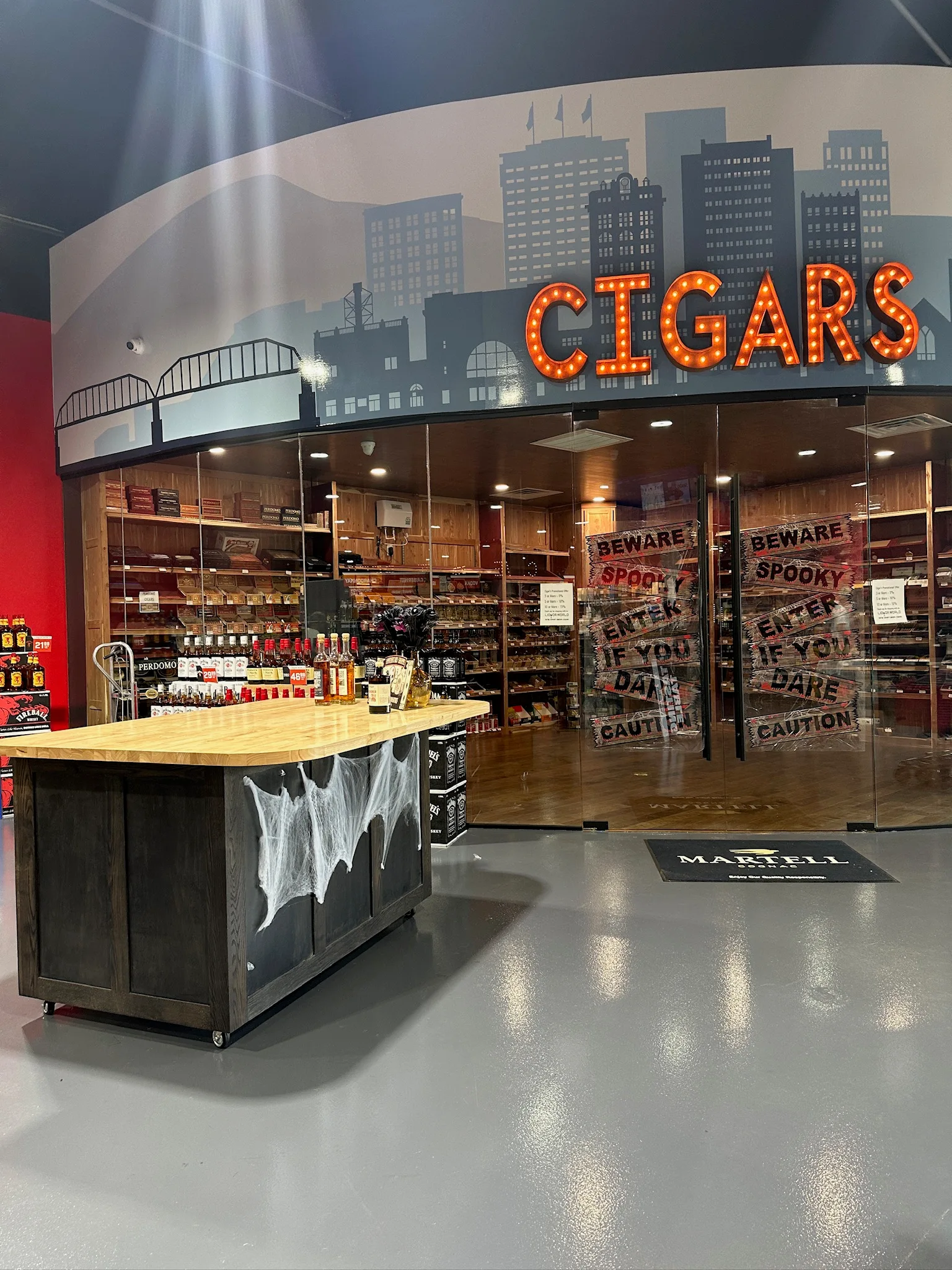 Custom cigar humidor room with cedar shelving and display island by Sims Custom Woodwork.