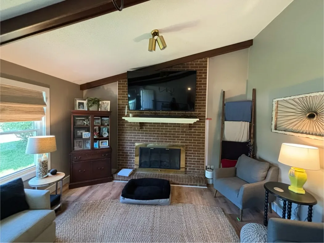 Custom white fireplace mantel on brick surround by Sims Custom Woodwork.