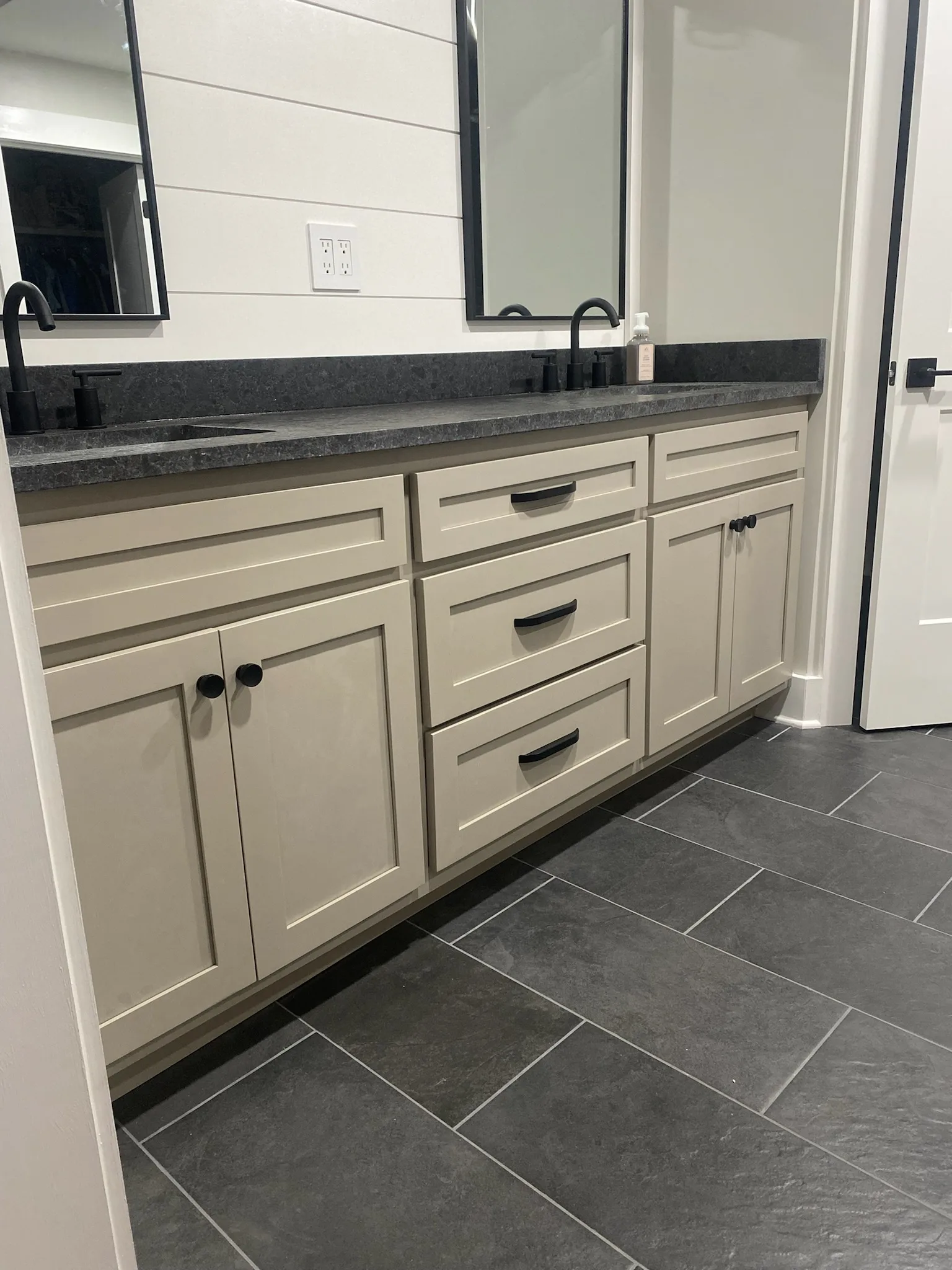 Custom double bathroom vanity with dark granite and matte black hardware by Sims Custom Woodwork — serving Chattanooga, TN and North Georgia.