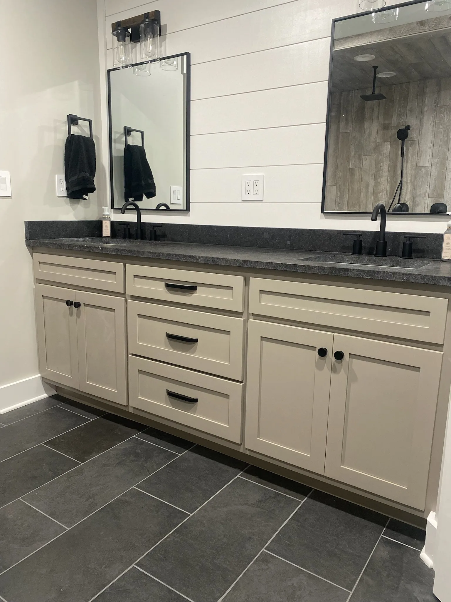 Full bathroom with custom double vanity, shiplap wall, and walk-in shower by Sims Custom Woodwork.