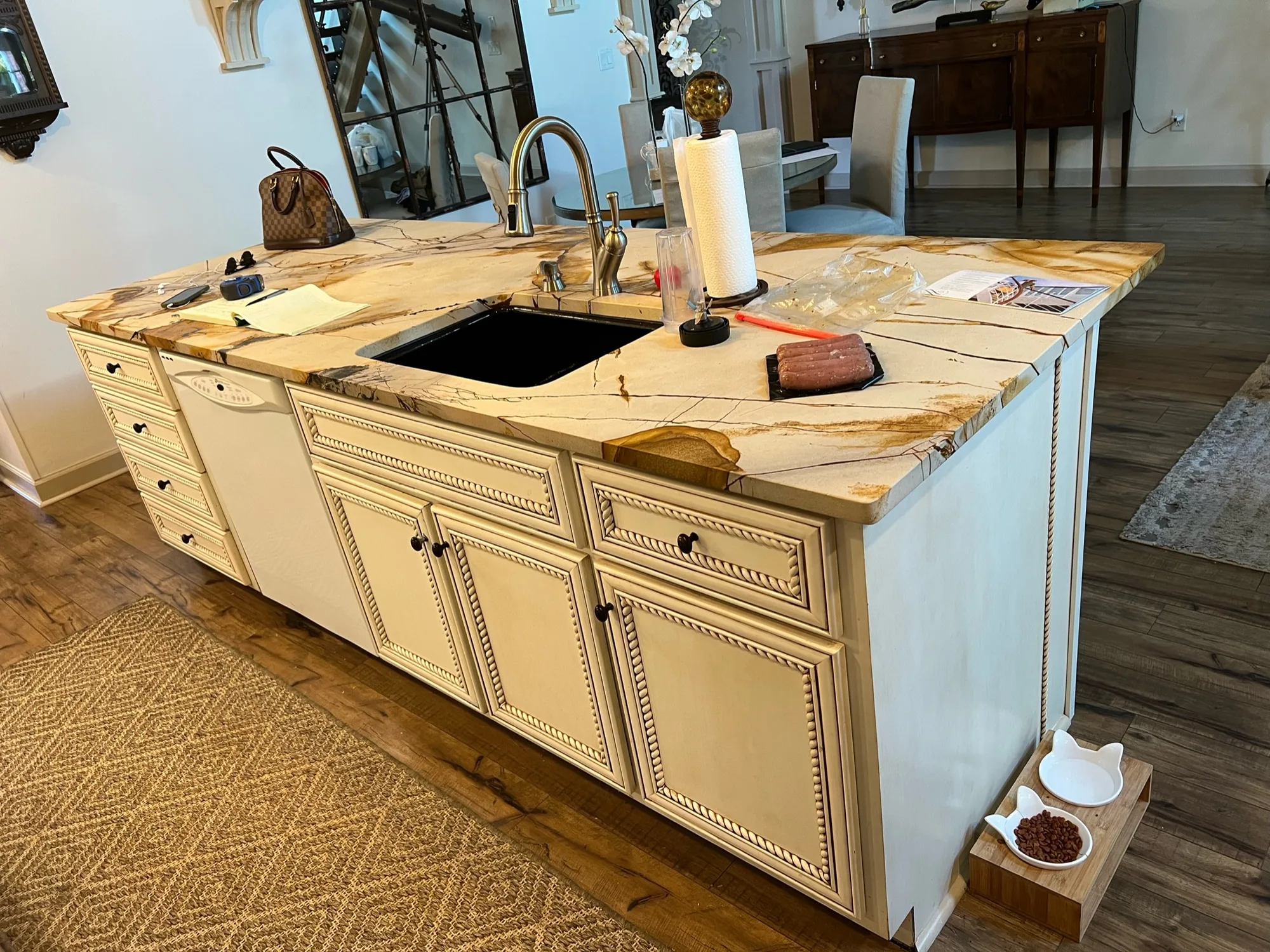 Large custom kitchen island with rope-detail cabinetry and exotic stone countertop by Sims Custom Woodwork.