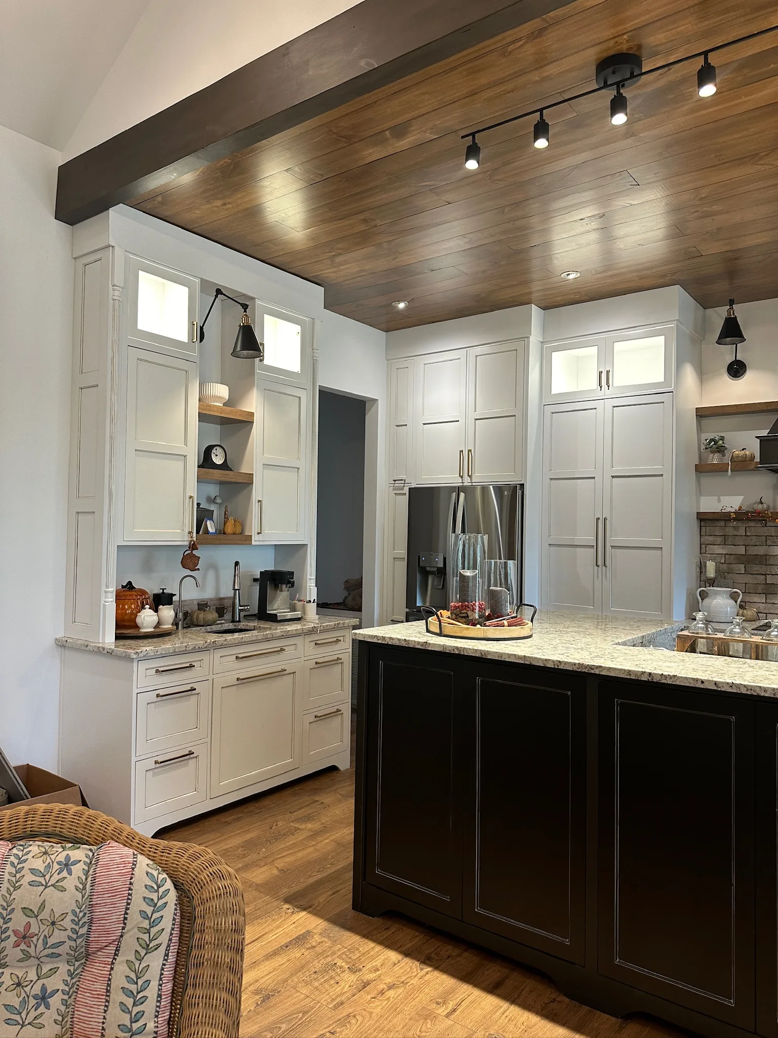 Farmhouse kitchen with dark island and white perimeter cabinets by Sims Custom Woodwork.