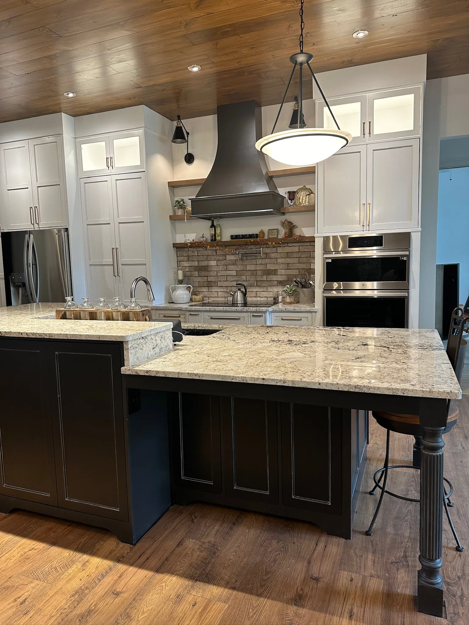 Farmhouse kitchen island with turned legs and bar seating by Sims Custom Woodwork.