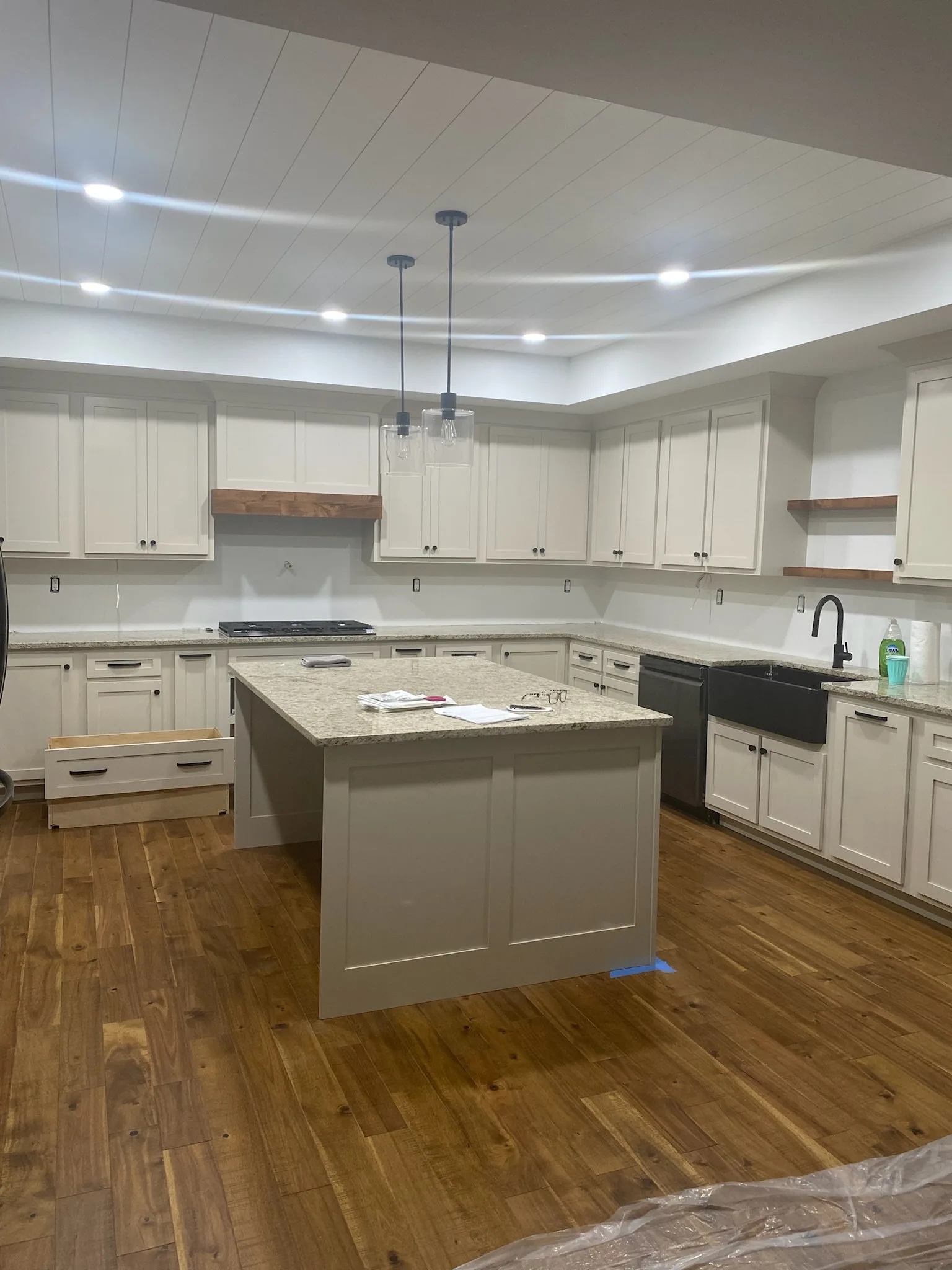 Custom white shaker farmhouse kitchen with island and shiplap ceiling by Sims Custom Woodwork — Chattanooga, TN and North Georgia.