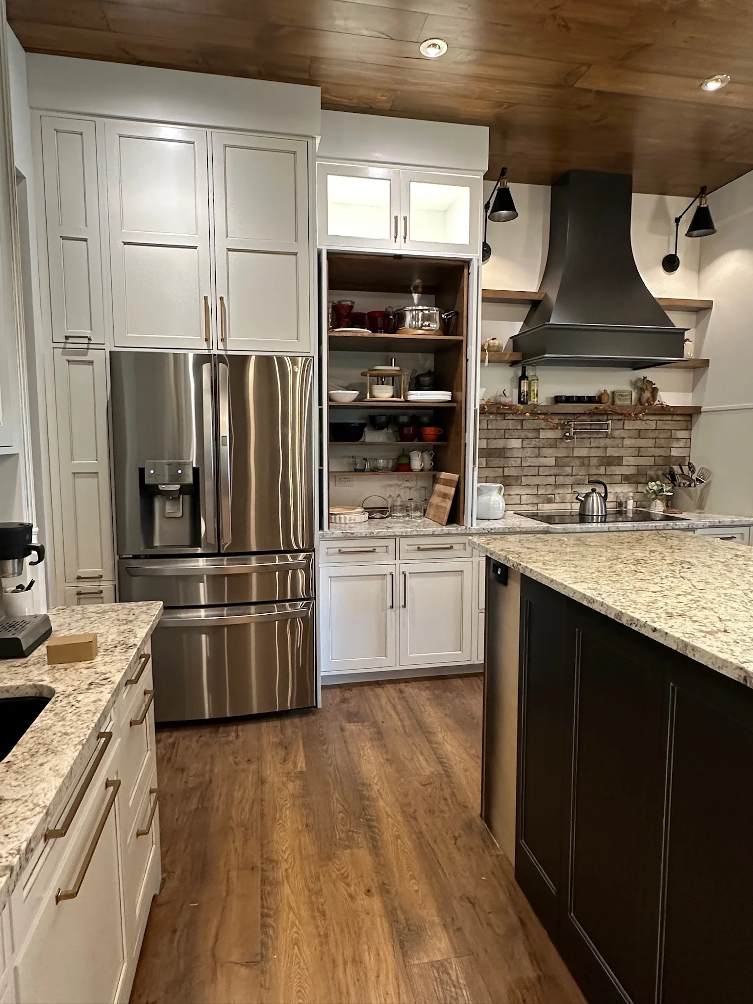 Farmhouse kitchen open pantry tower with wood shelves by Sims Custom Woodwork.