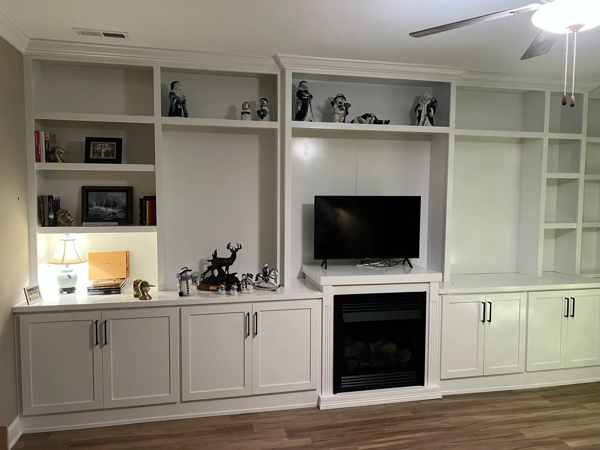 Wall-to-wall entertainment center with fireplace and built-in shelving by Sims Custom Woodwork.