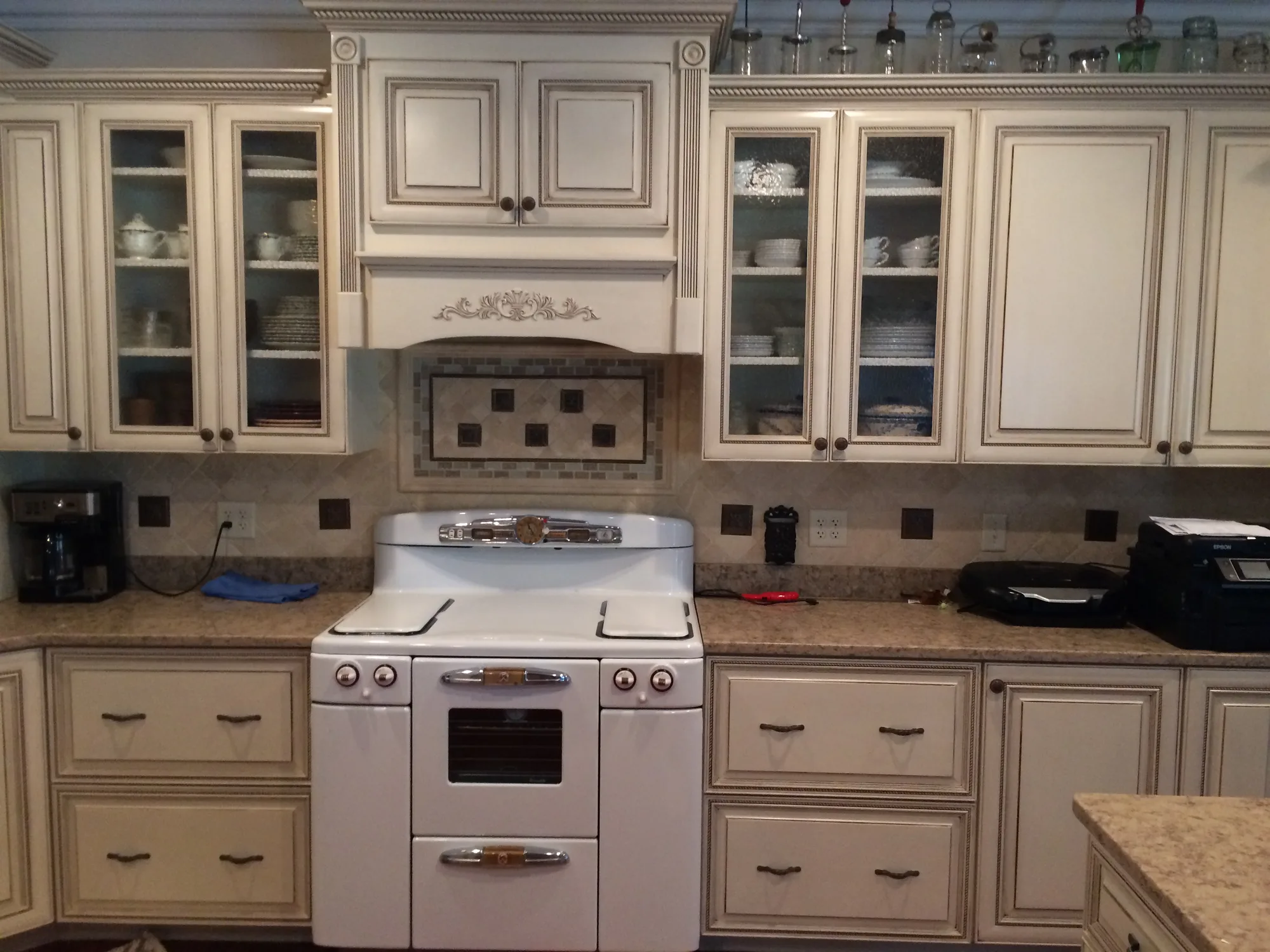 Upper kitchen cabinets with crown molding by Sims Custom Woodwork.