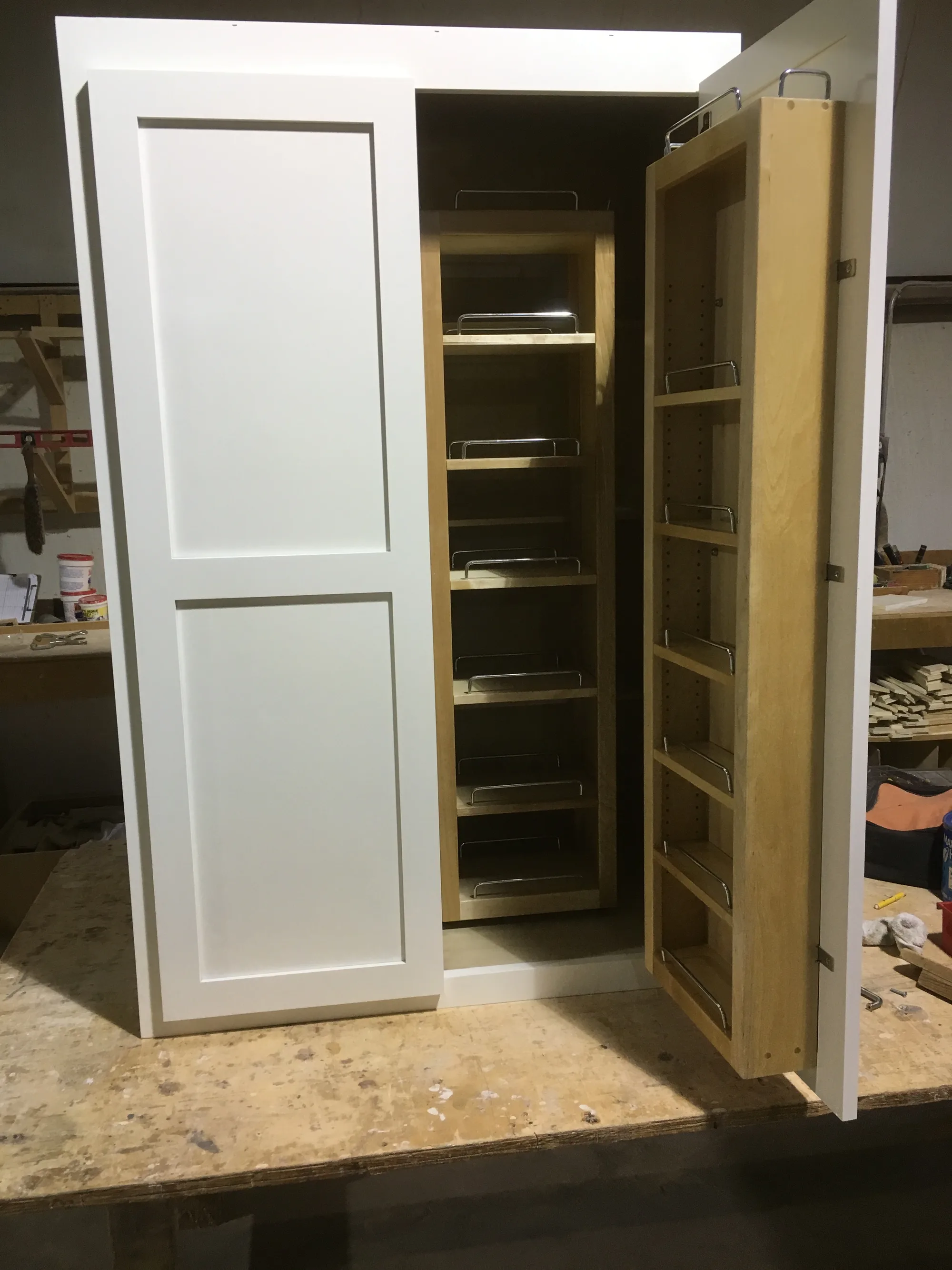 Custom built-in pantry cabinets with adjustable shelving by Sims Custom Woodwork.