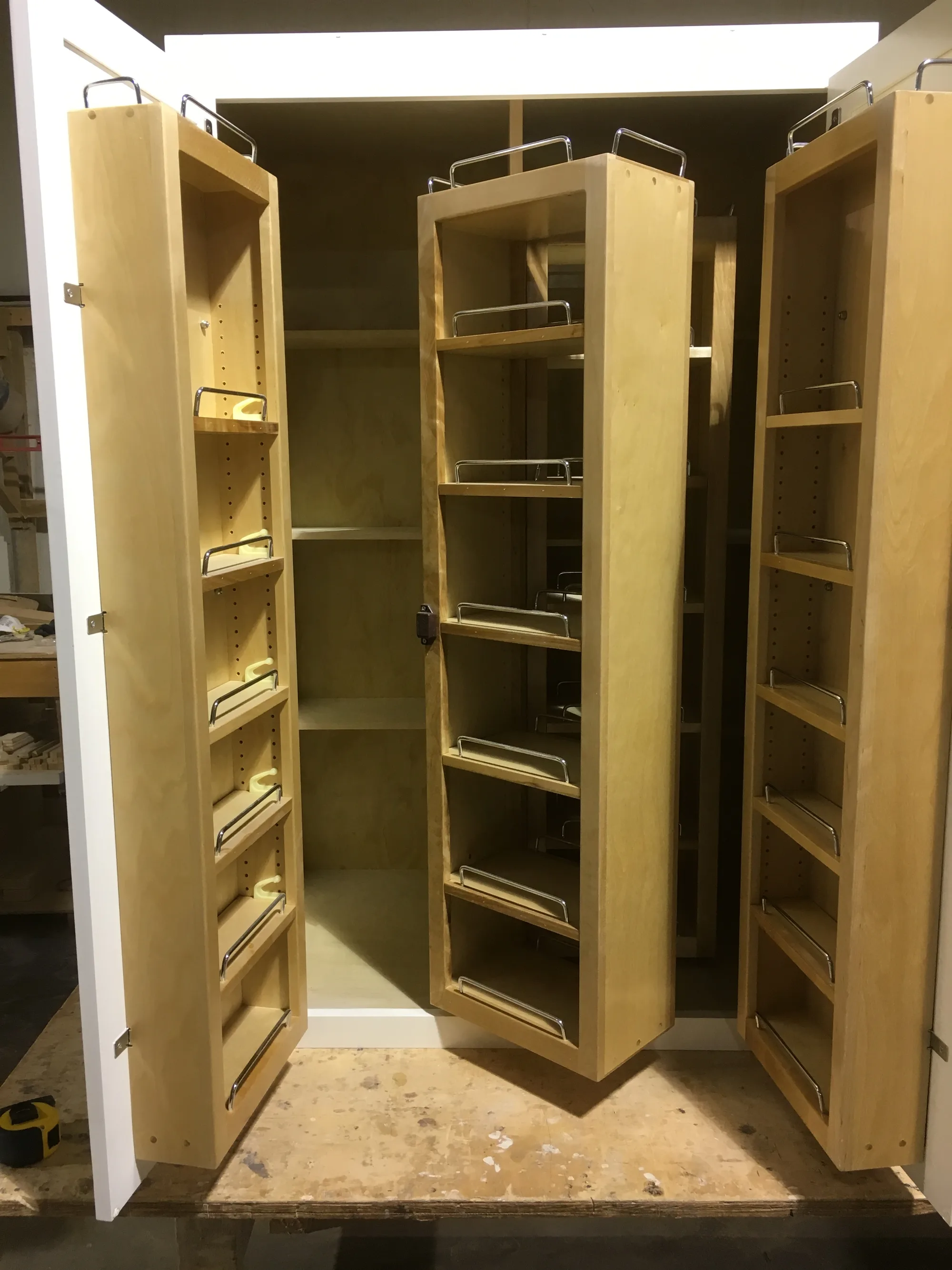 Built-in pantry with pull-out drawers and fixed shelves.