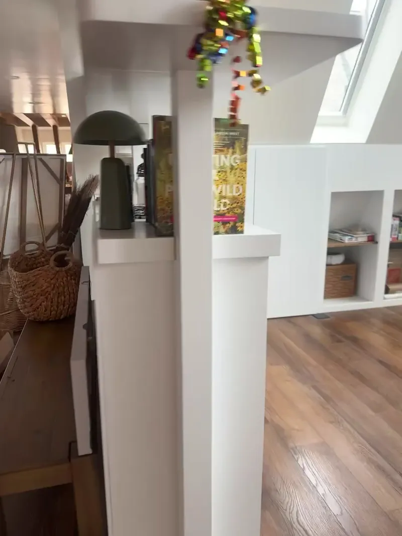 Video walkthrough of white built-in bookshelf room divider with exposed beams by Sims Custom Woodwork.