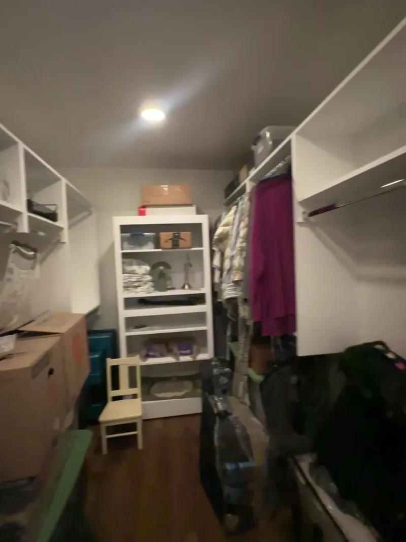 Video tour of custom walk-in closet organizer with white built-in shelving by Sims Custom Woodwork.
