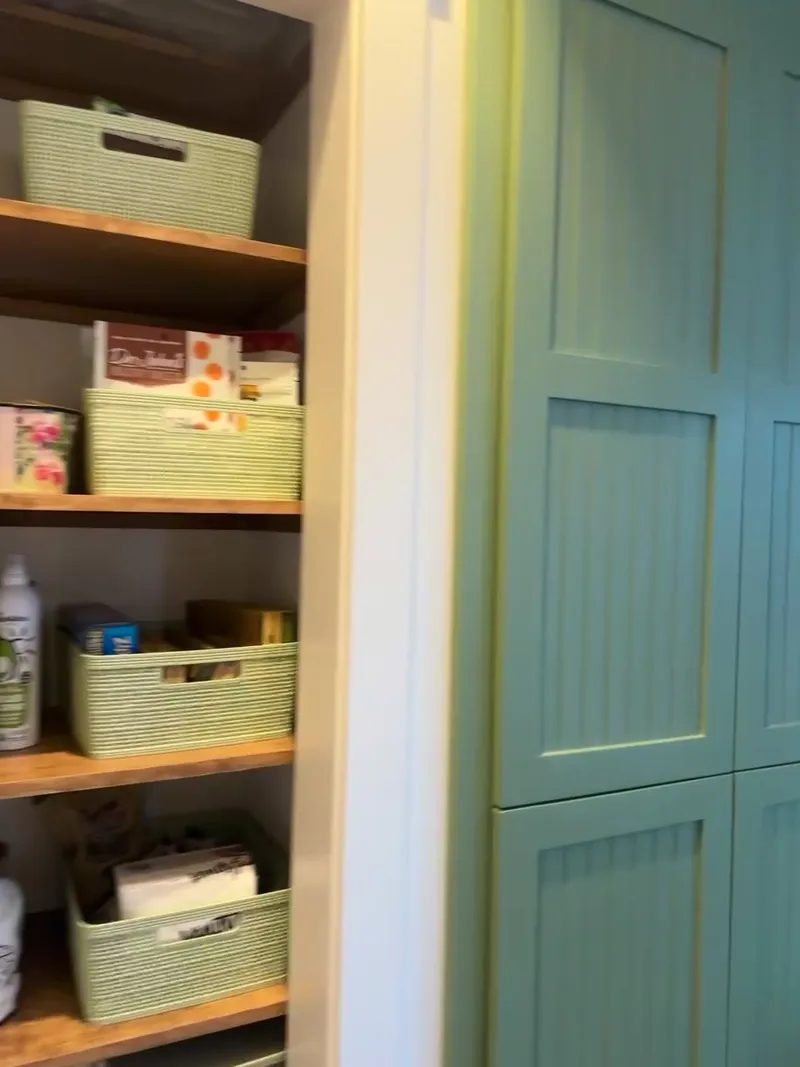 Video walkthrough of rustic pantry with live-edge shelves and sage green beadboard door by Sims Custom Woodwork.