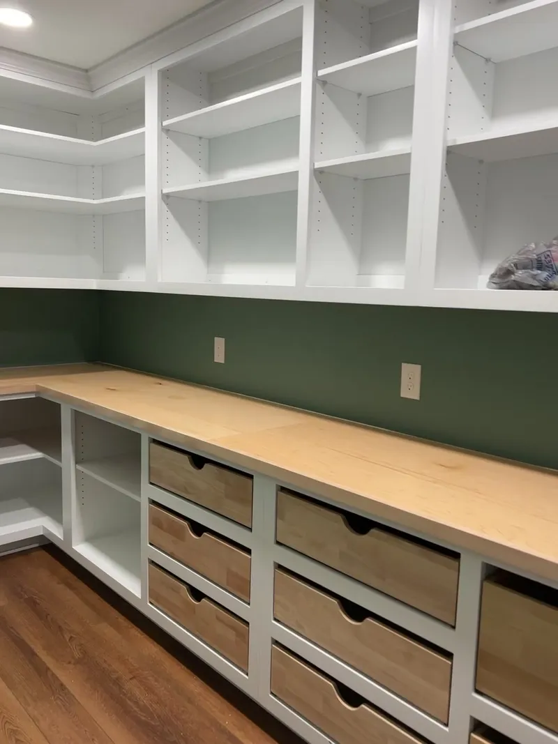 Video tour of green pantry with natural wood drawers and butcher block counter by Sims Custom Woodwork.