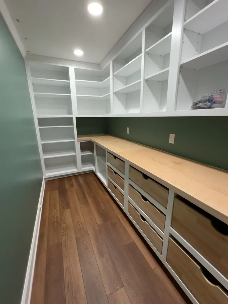 Video tour of full L-shaped green pantry with built-in shelving by Sims Custom Woodwork.