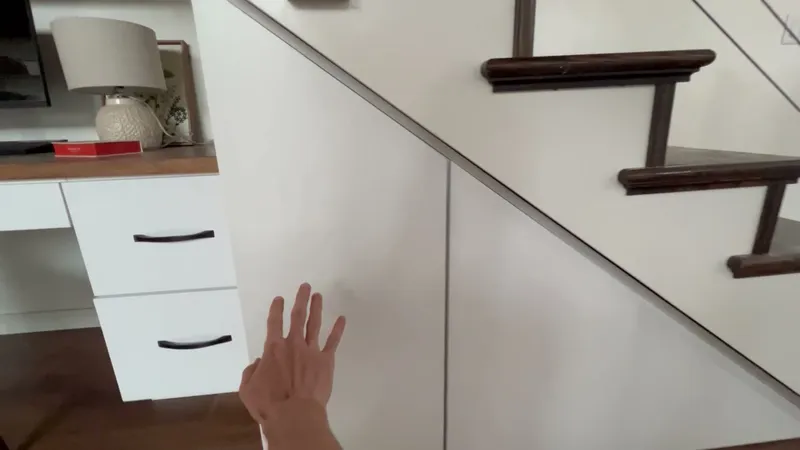Video demo of hidden under-stair push-open storage cabinets by Sims Custom Woodwork.