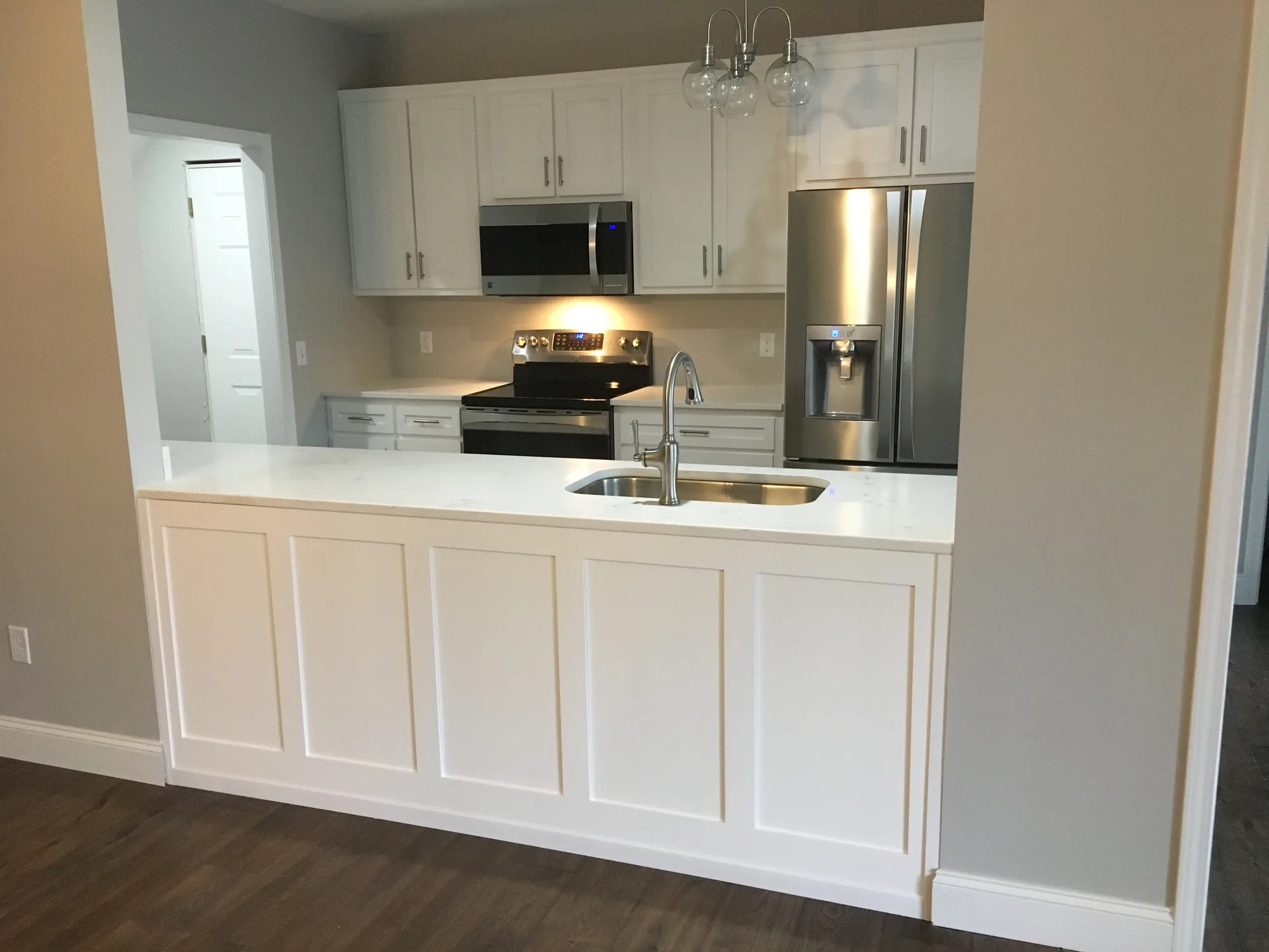 Custom white shaker kitchen cabinets with center island by Sims Custom Woodwork in Trenton, GA — serving Chattanooga, TN and North Georgia.