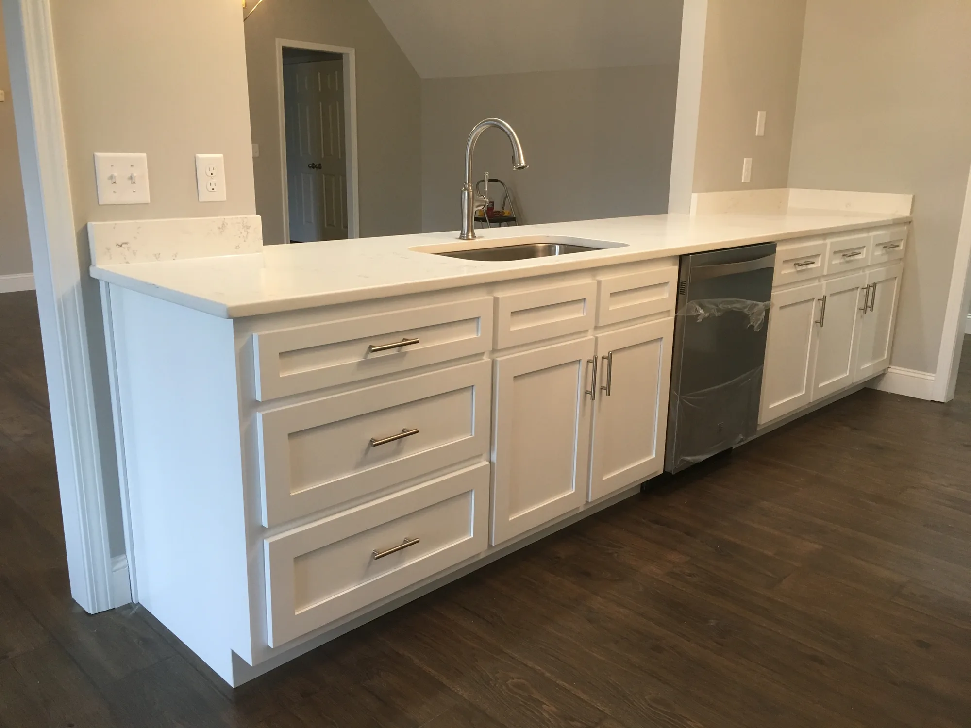 White shaker cabinet door detail with brushed hardware by Sims Custom Woodwork.