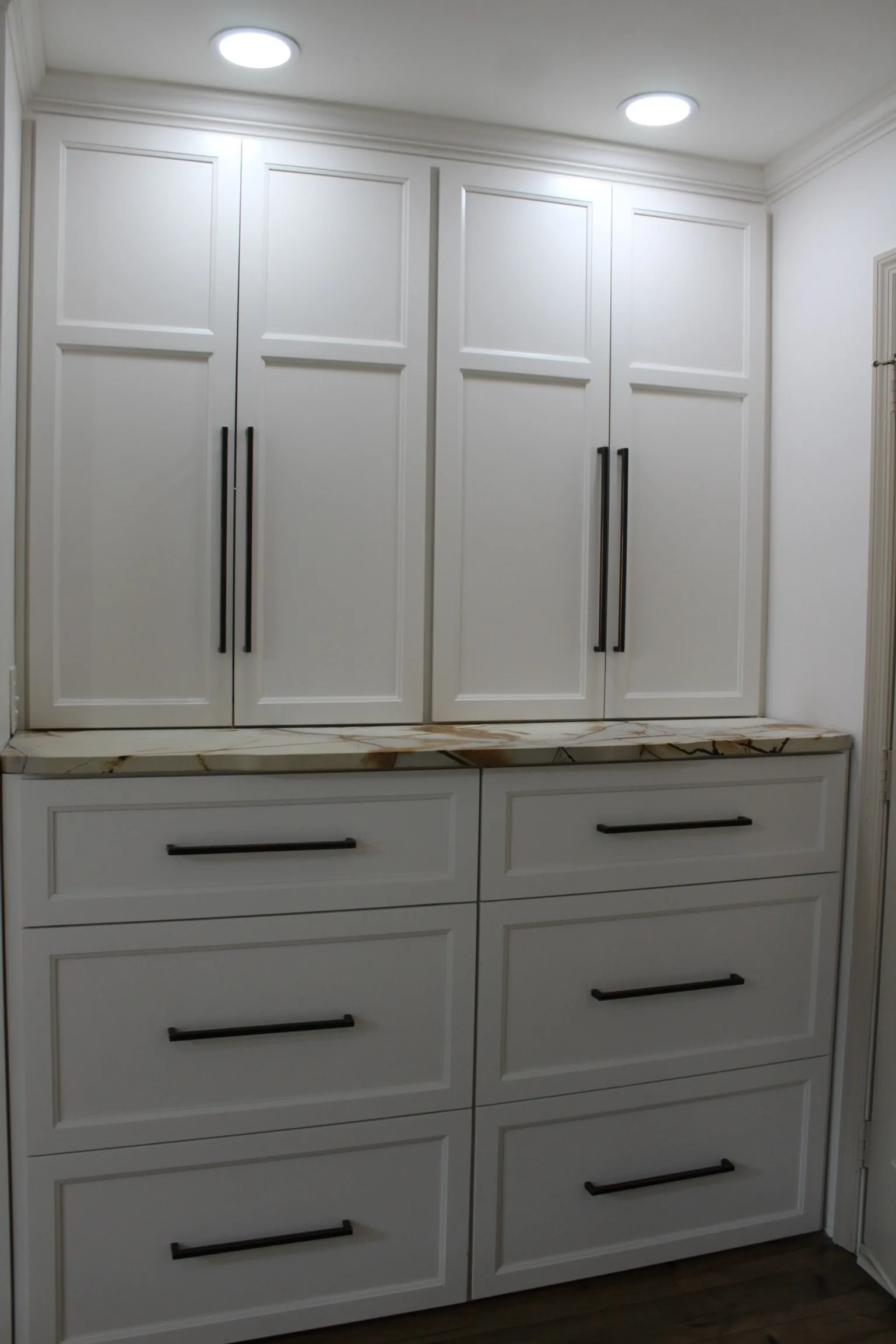 White shaker pantry hutch with drawer stack and exotic marble countertop by Sims Custom Woodwork.