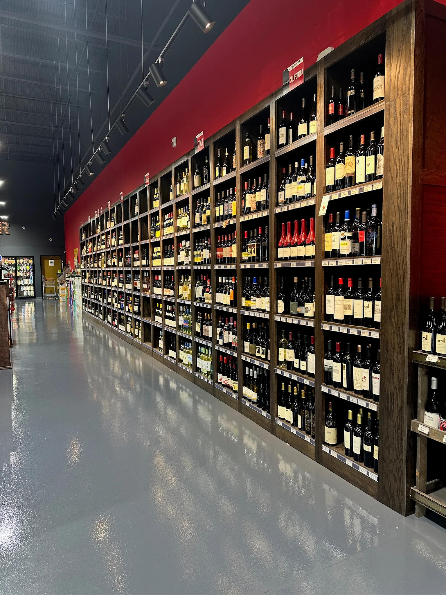 Commercial wine display shelving in dark stained wood by Sims Custom Woodwork.